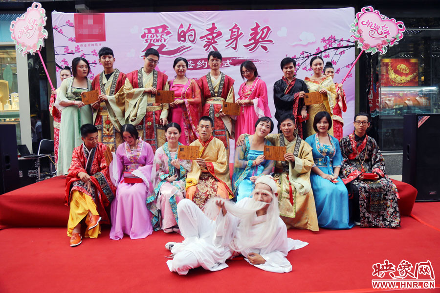 現(xiàn)場8對兒年輕男女舉起“賣身契”集體拍照。