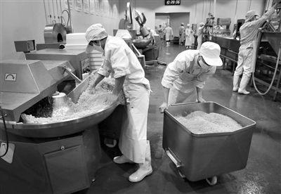 昨日，位于順義李遂開發(fā)區(qū)的慶豐包子鋪配送中心生產(chǎn)車間，工人們正在斬拌胡蘿卜餡料。