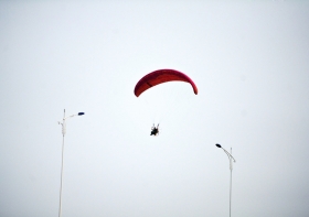 10月25日下午，動力傘從一對路燈上空飛過