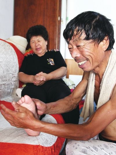 慈成富為老伴按摩。