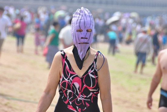 2013年7月3日，山東青島青島高溫來襲，“青島大媽”不懼滸苔，戴著“強(qiáng)盜面具”出現(xiàn)在海水浴場(chǎng)消暑降