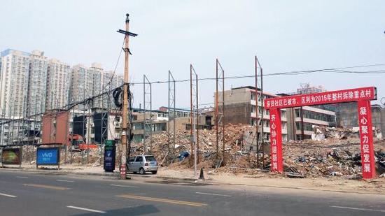 015年5月31日，在社區(qū)干部的帶頭拆遷下，親賢社區(qū)的“城中村改造”拉開帷幕。由于前期“清產(chǎn)核資”及補償標(biāo)準(zhǔn)等因素，拆遷改造工作推進并不順利。圖為位于體育西路東側(cè)集體所有的商鋪率先被拆遷完畢，用于遮擋的圍擋正在施工中。（拍攝：2015年9月16日）