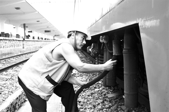 昨日，商丘火車站給水員在烈日下工作