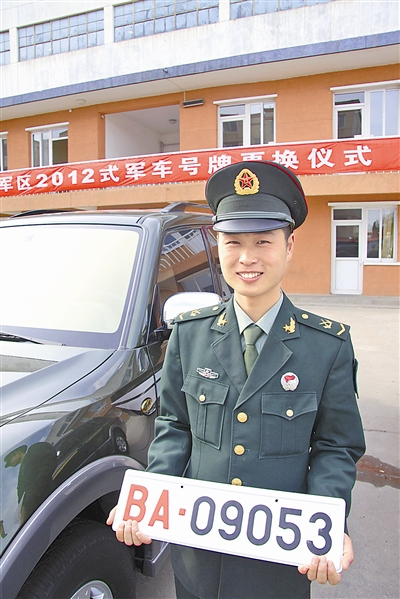 駐京某部長途汽車隊中士王志濤領(lǐng)到新式軍車號牌。